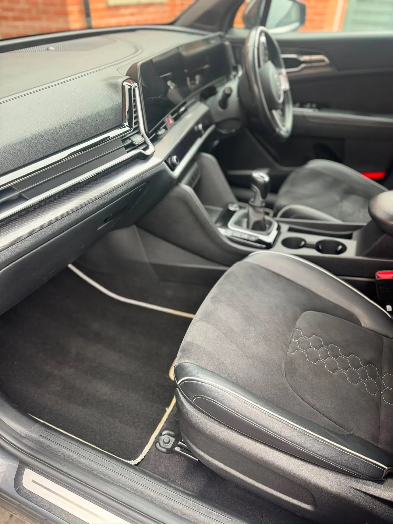 The same driver's side finished — carpets and mats clean, dash and console wiped down.
